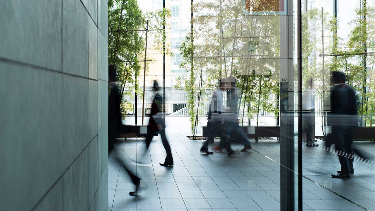 business people walking in office lobby